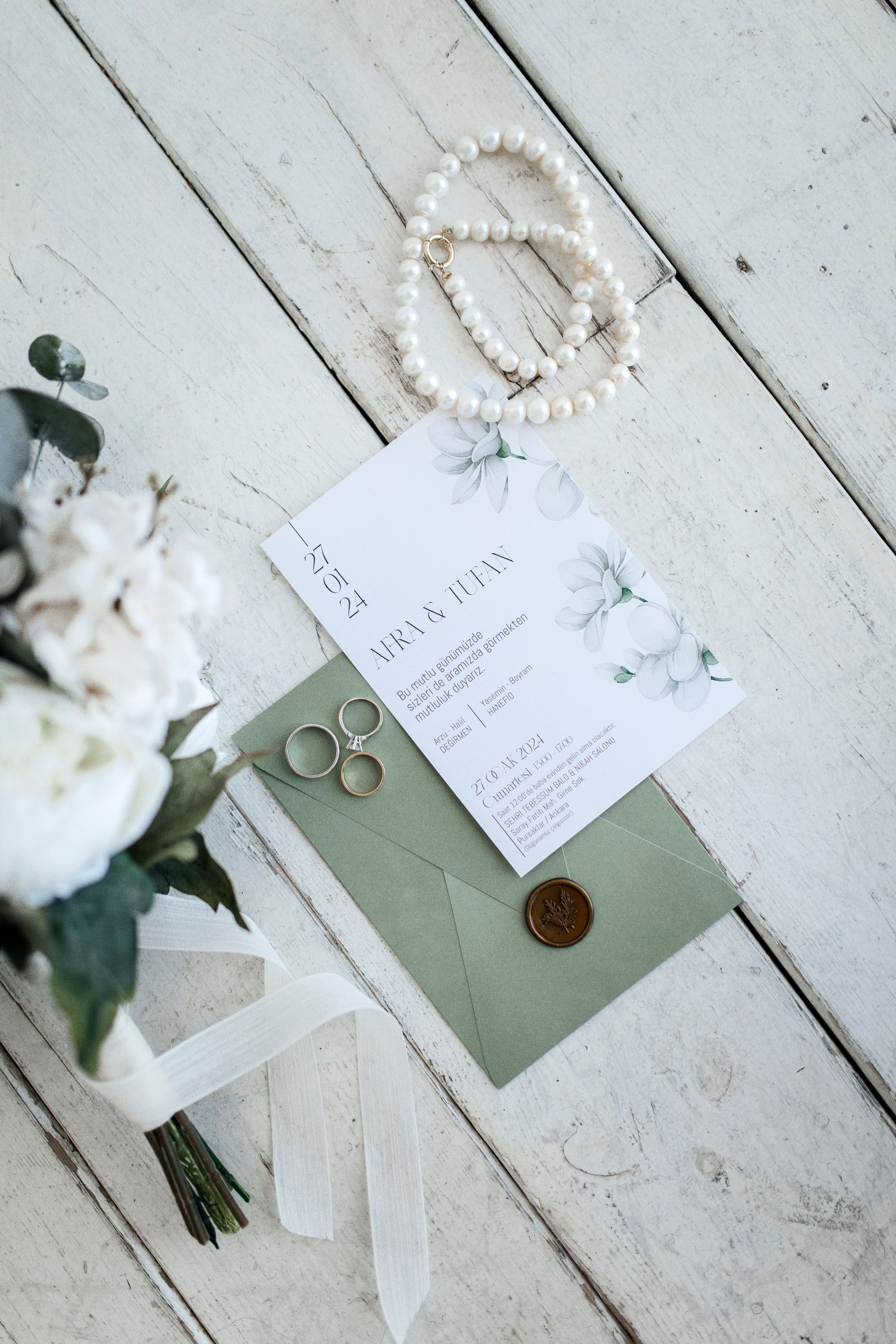 Wedding rings arranged with an invitation suite